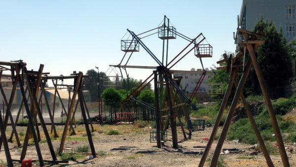 Children of curfew-struck Cizre and hollow wooden swings