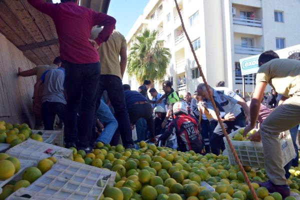 Bir kamyon portakalın altında kalan otomobil sürücüsünü kurtarma seferberliği
