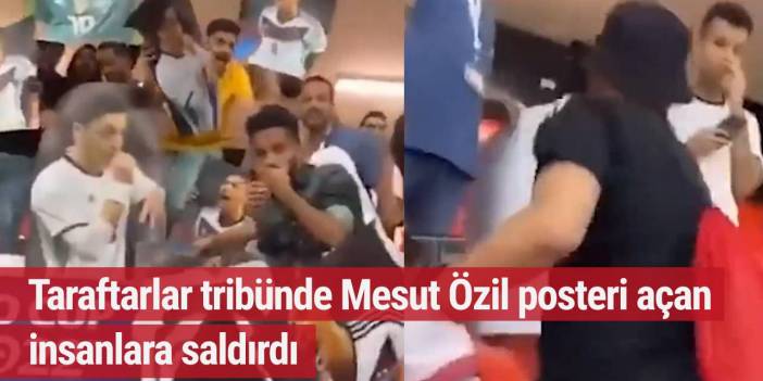 Taraftarlar tribünde Mesut Özil posteri açan insanlara saldırdı
